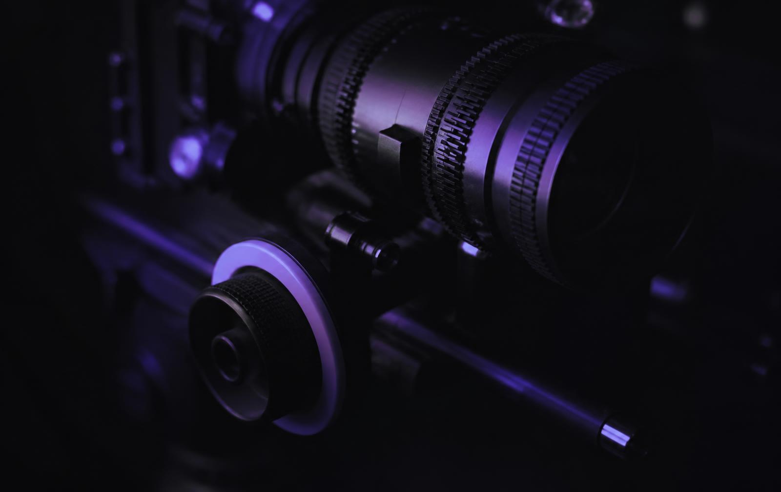 Professional cinema camera rig detail lit in deep violet